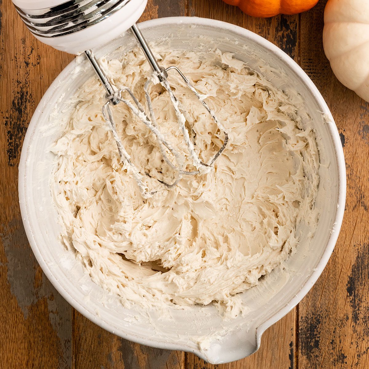 mixing bowl with whipped salted caramel buttercream frosting.
