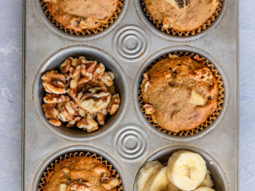 muffin tin full of banana muffins, walnuts, and banana slices