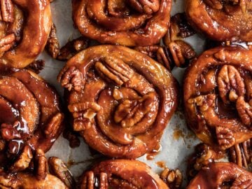 vegan sticky buns on a baking tray with pecans