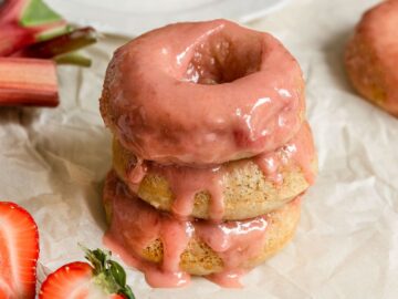 stack of three donuts with strawberry rhubarb glaze dripping off top