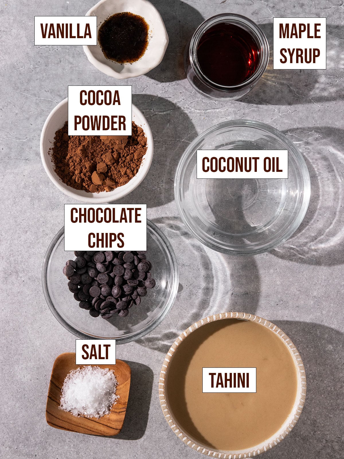 labeled ingredients including tahini, chocolate chips, cocoa powder, vanilla, maple syrup, coconut oil, chocolate chips, and salt.