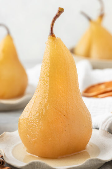 poached pear on a fluted plate