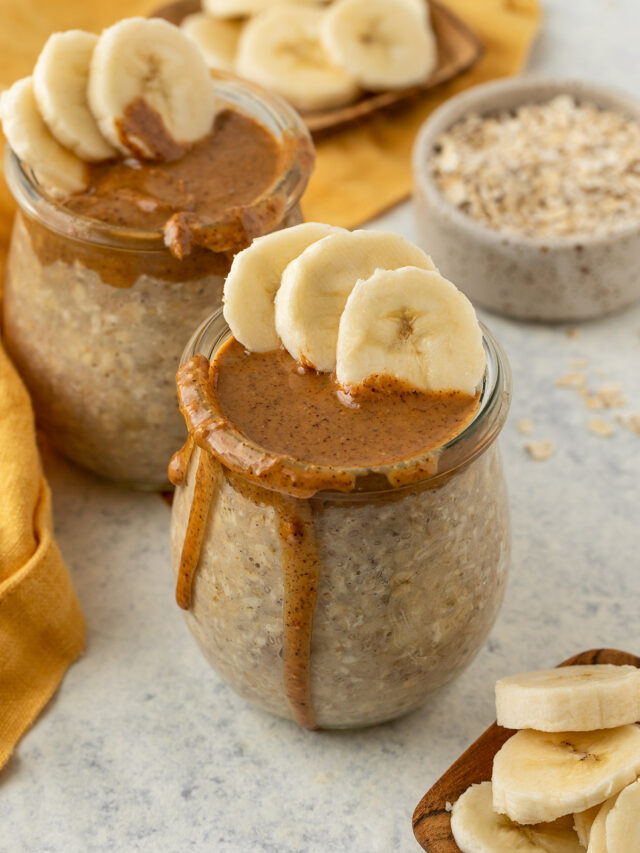 glass jars filled with overnight oats and topped with almond butter and sliced bananas.
