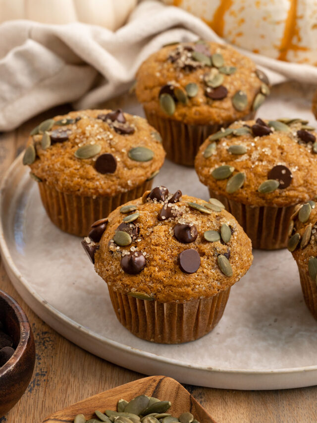 plate of pumpkin muffins with chocolate chip and pepitas.