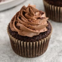 a chocolate cupcake topped with chocolate buttercream swirls and shaved chocolate.