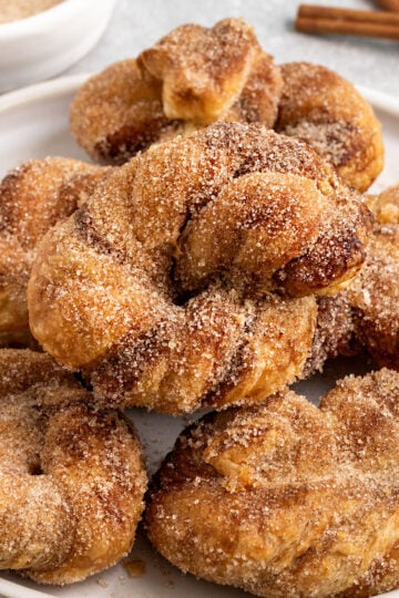 plate with stacked cinnamon sugar knots.