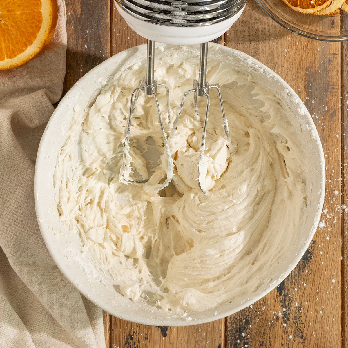 frosting in mixing bowl with hand mixer.