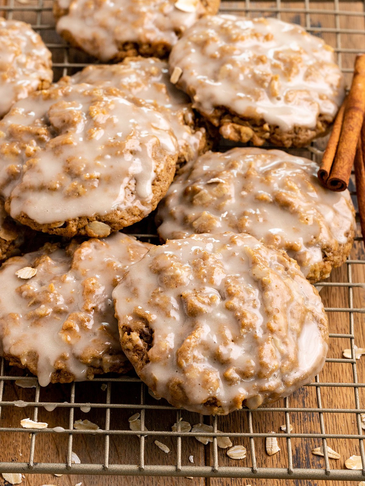 stack of frosted oatmeal cookies on a wire cooling rack.