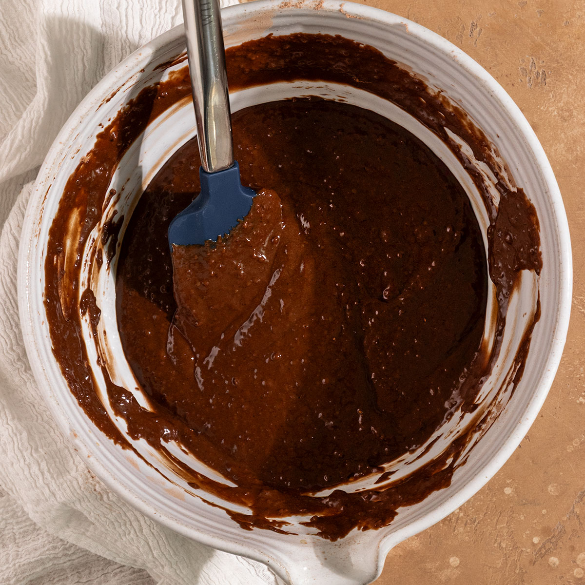 chocolate cake batter with a spatula in a bowl.