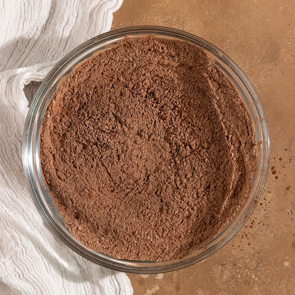 sifted flour, cocoa powder, and other dry ingredients in a glass mixing bowl.