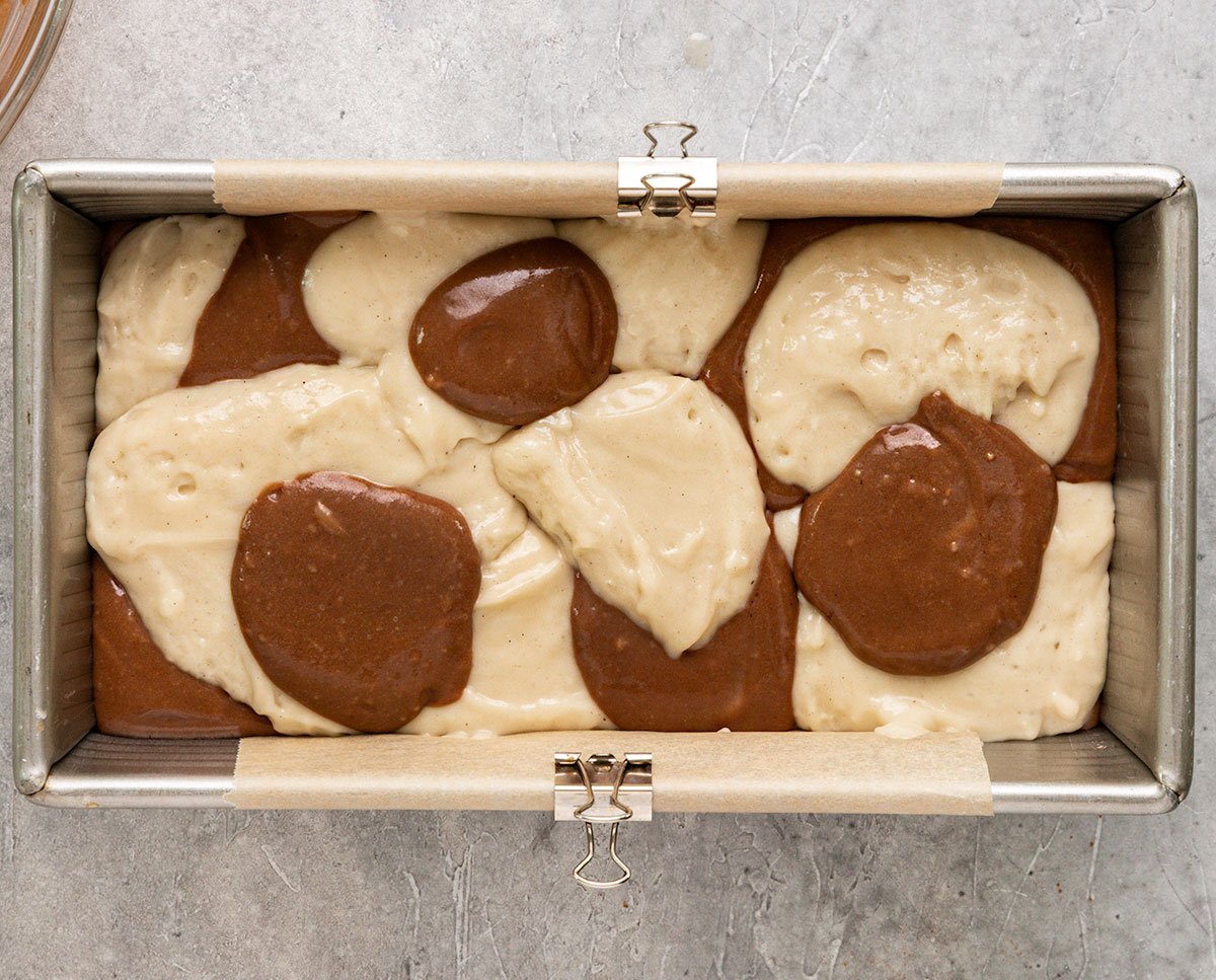 chocolate and vanilla cake batter in a loaf pan.