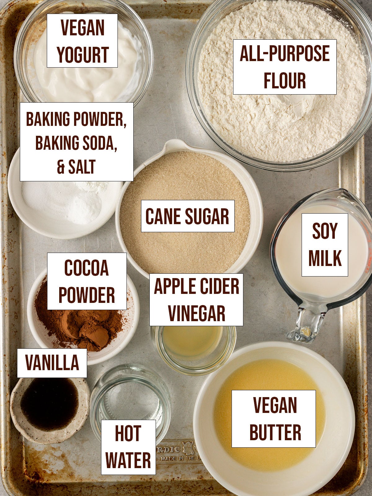 marble cake ingredients labeled and on a baking tray.