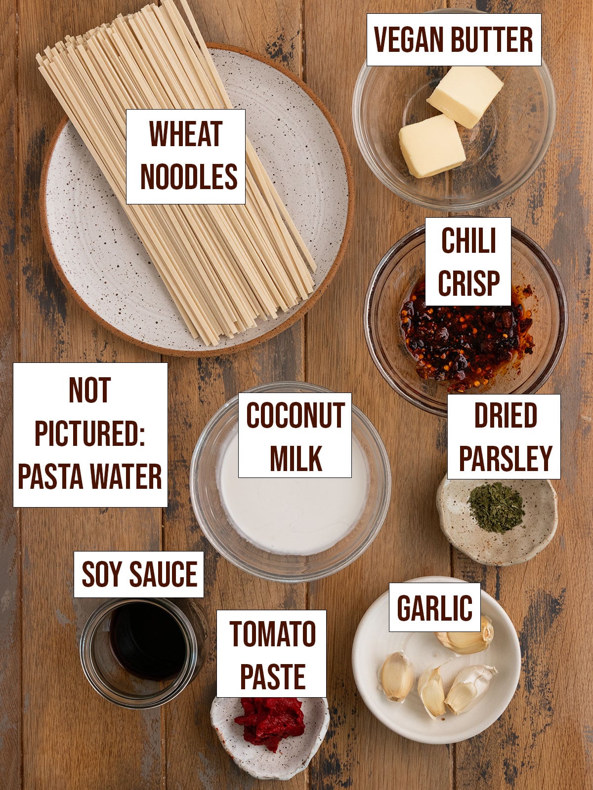 labeled ingredients including noodles, chili crisp, butter, parsley, coconut milk, soy sauce, tomato paste, and garlic.