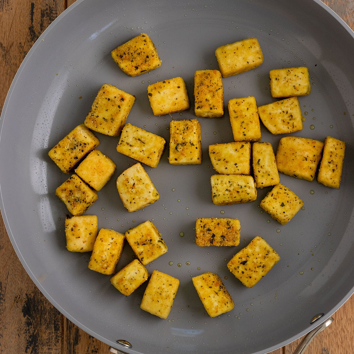 cooked and seasoned tofu cubes in a pan.