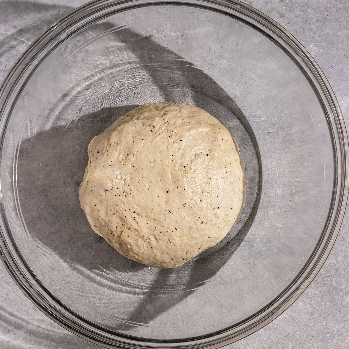 glass bowl with a ball of earl grey dough.