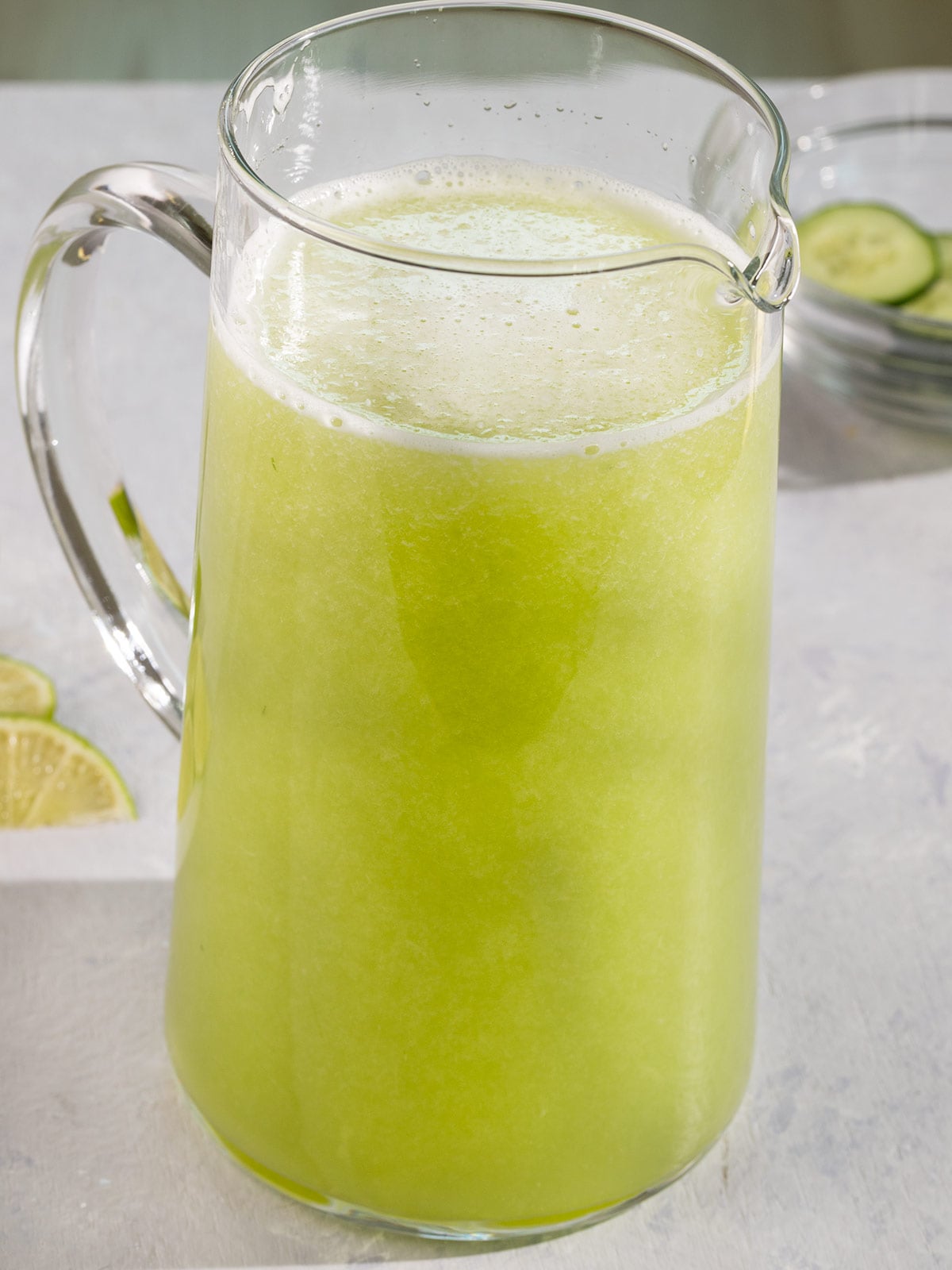 large pitcher filled with green juice.
