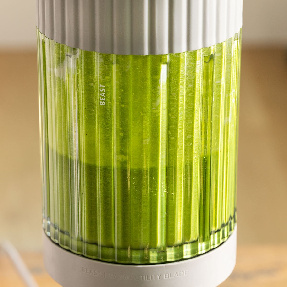 green basil cream sauce in a standing blender.
