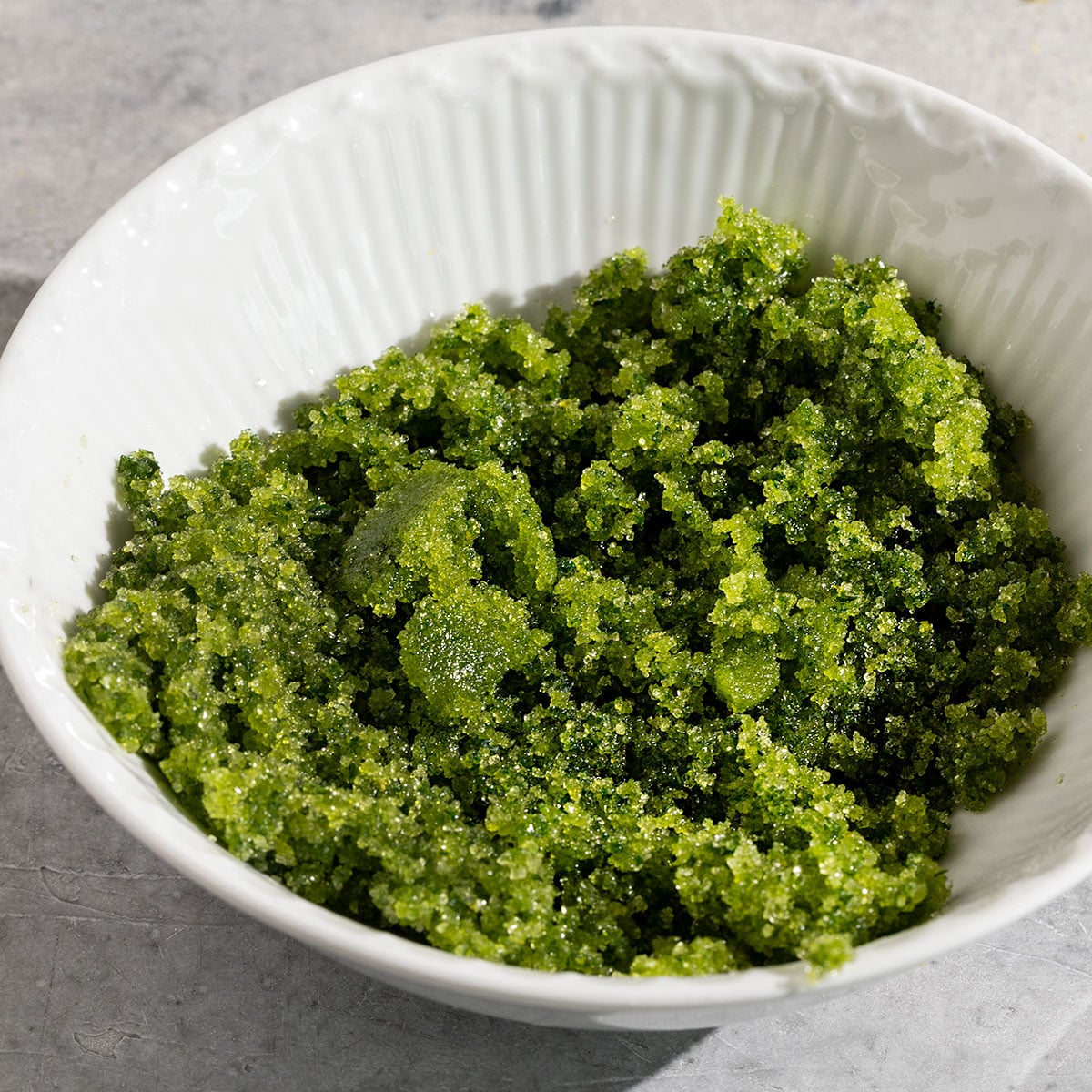 bowl of blended green basil lemon sugar.