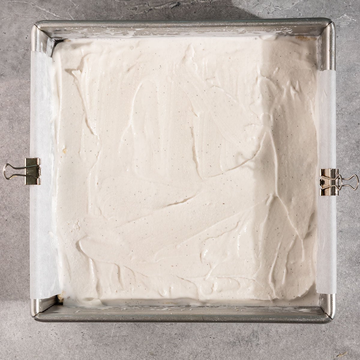 layer of cookie dough & vanilla ice cream pressed into a parchment lined 8 by 8 inch pan.