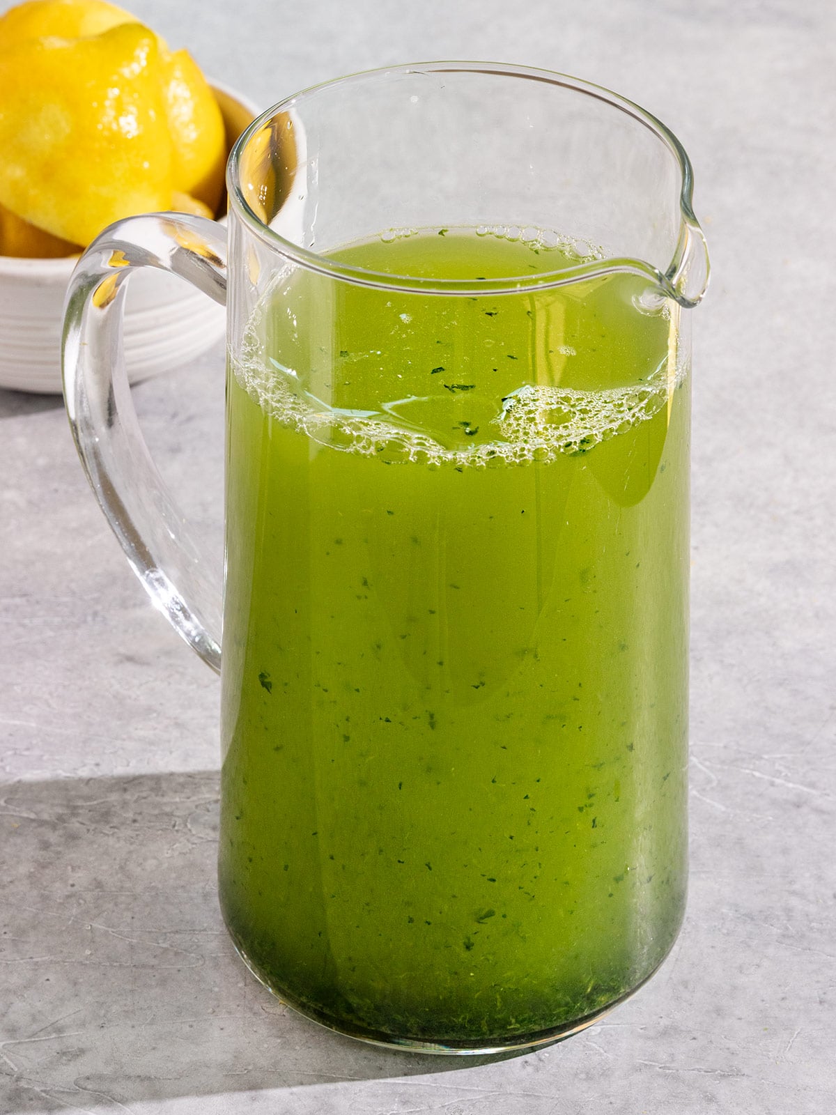 pitcher of green lemonade with basil.