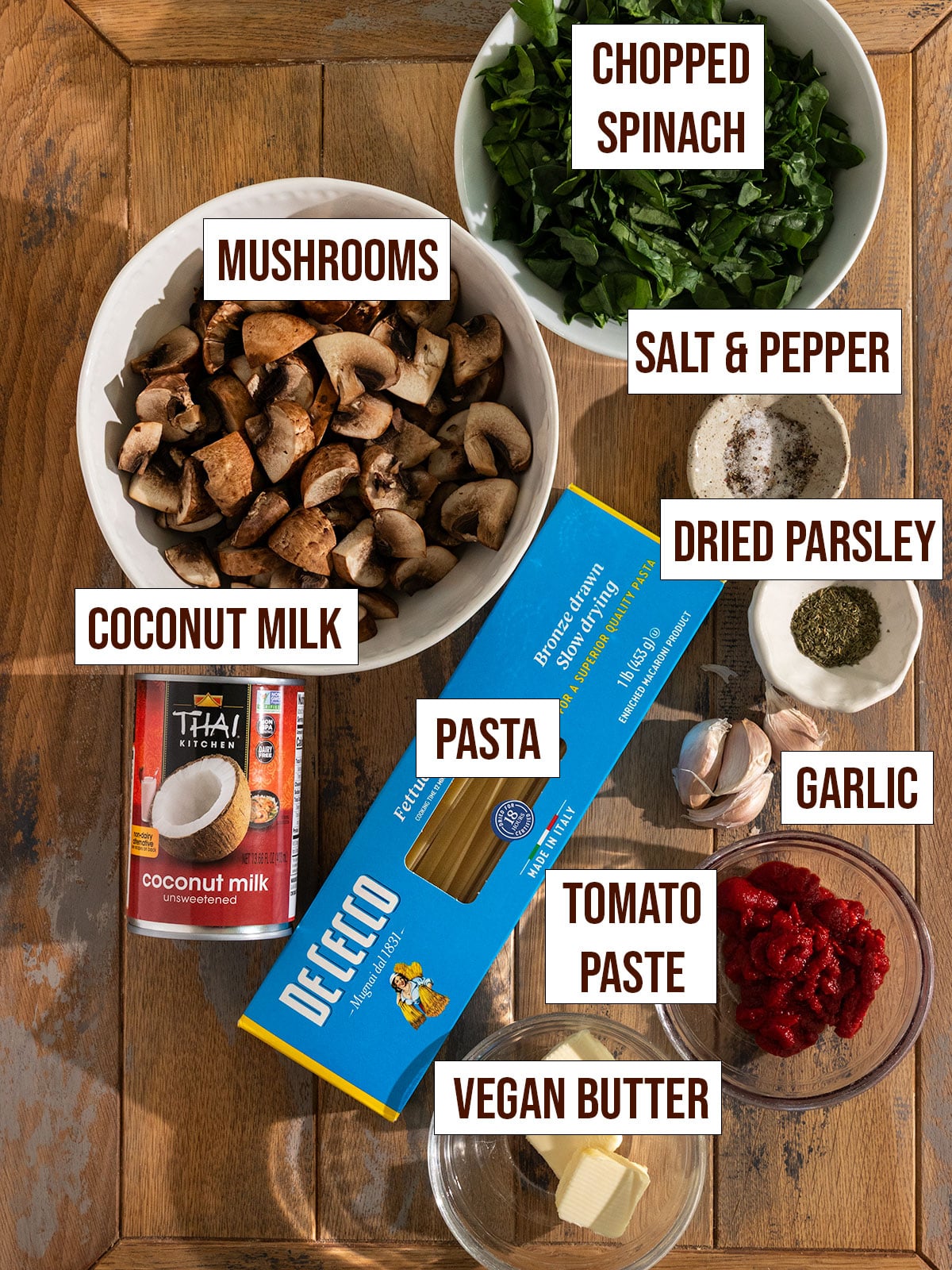 labeled ingredients for mushroom spinach pasta with creamy tomato paste sauce.