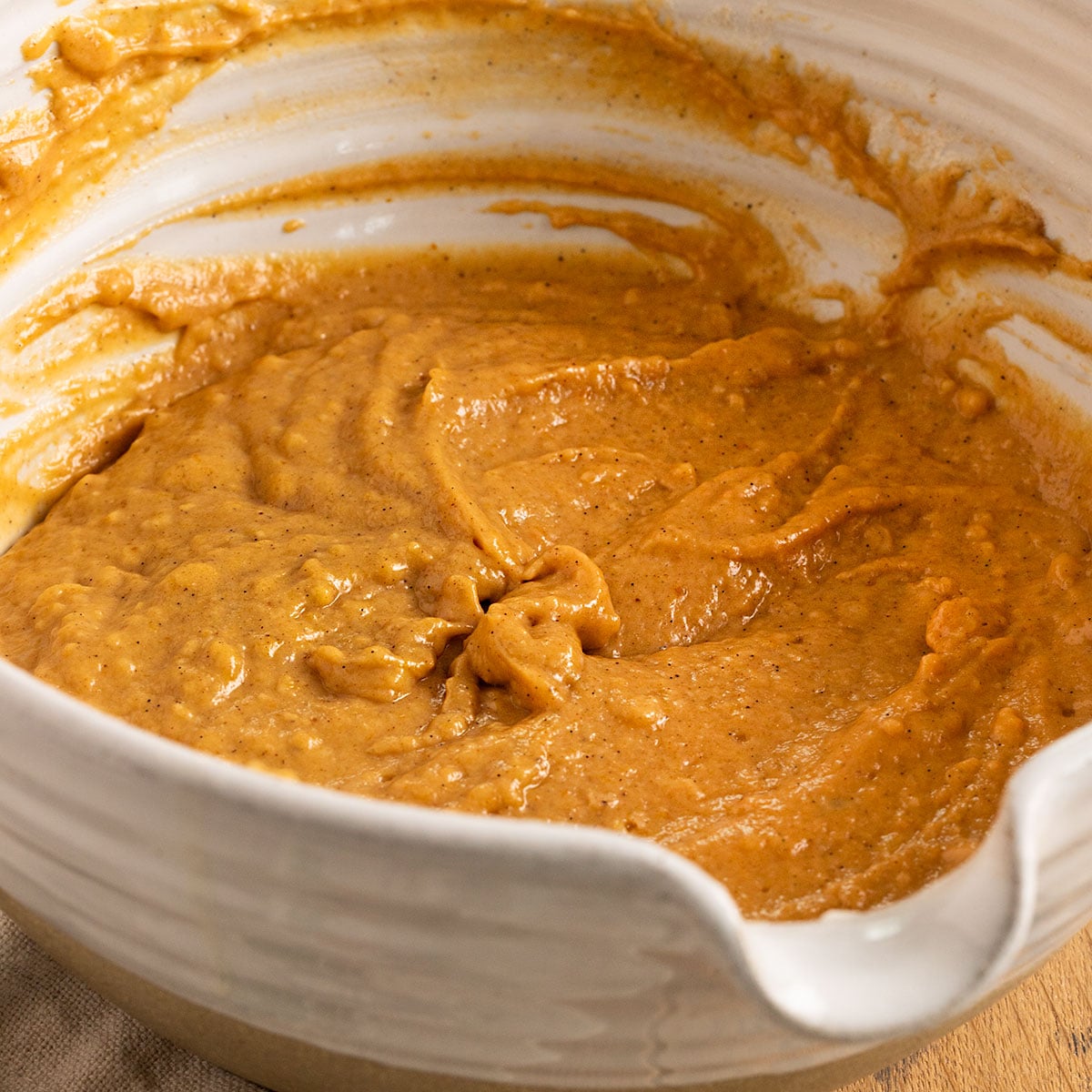 bowl of orange pumpkin cake batter.