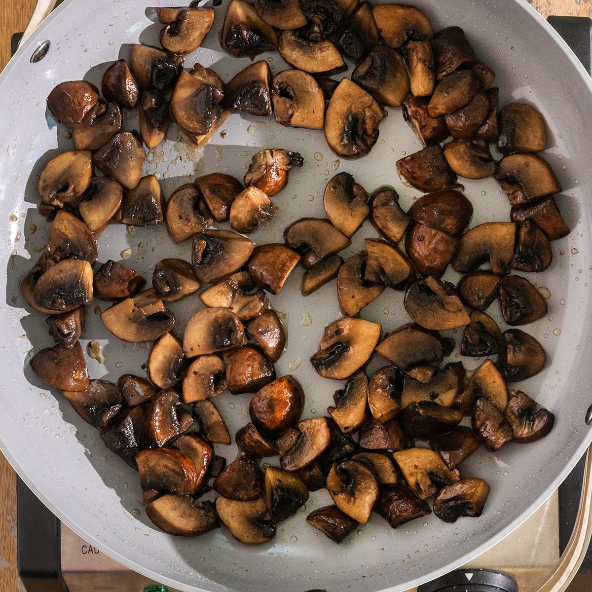 pan filled with sautéed and browned sliced mushrooms.