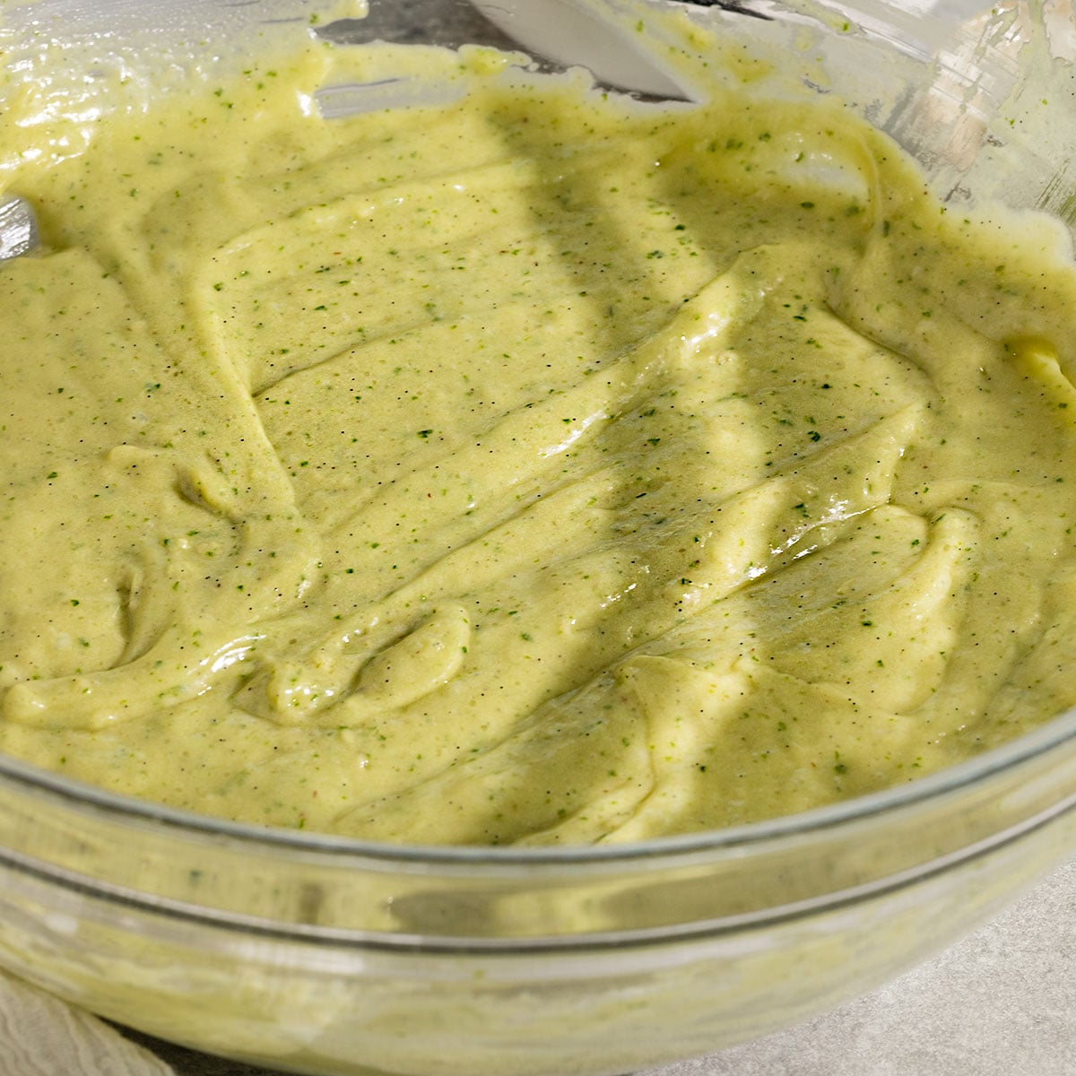 bowl of green cake batter.
