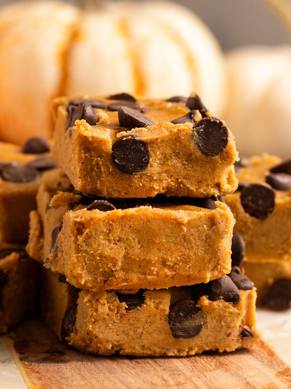three slices of pumpkin fudge filled with chocolate chips stacked on top of eachother.