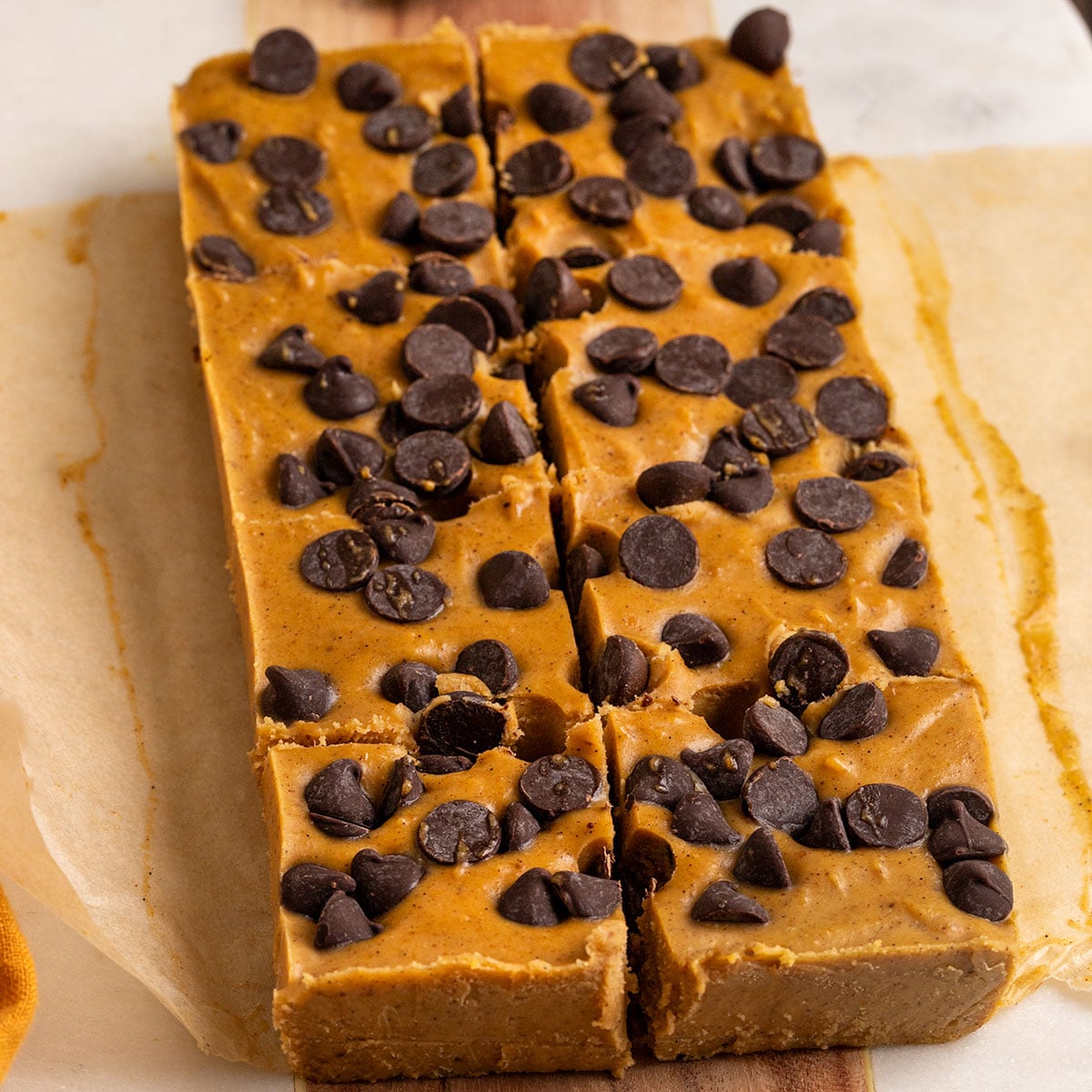 slice of pumpkin fudge with chocolate chips cut into 8 squares.