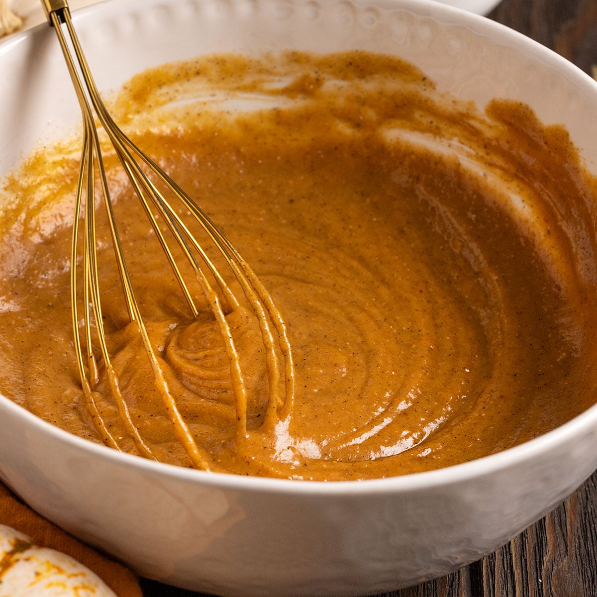 bowl of pumpkin fudge batter with a whisk.